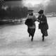 Two women skating hand-in-hand in a London park in 1919.